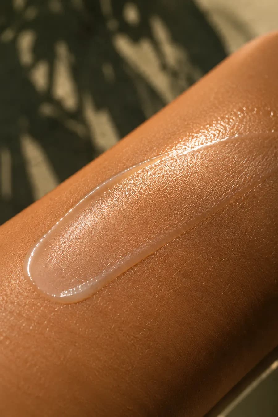 Macro of a translucent SPF film on Indian skin tone — no white residue, matte finish.